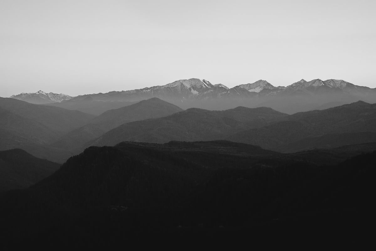 Black and White Mountains Under White Sky